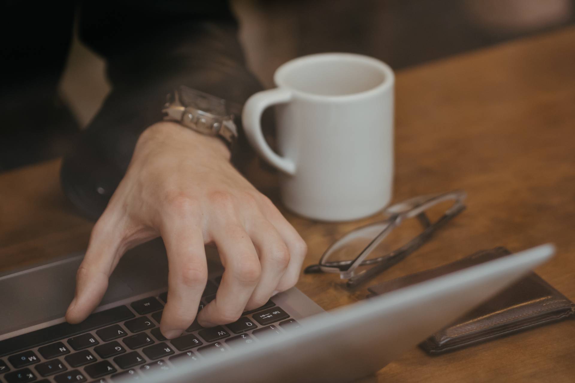 A person working with a laptop on a table
