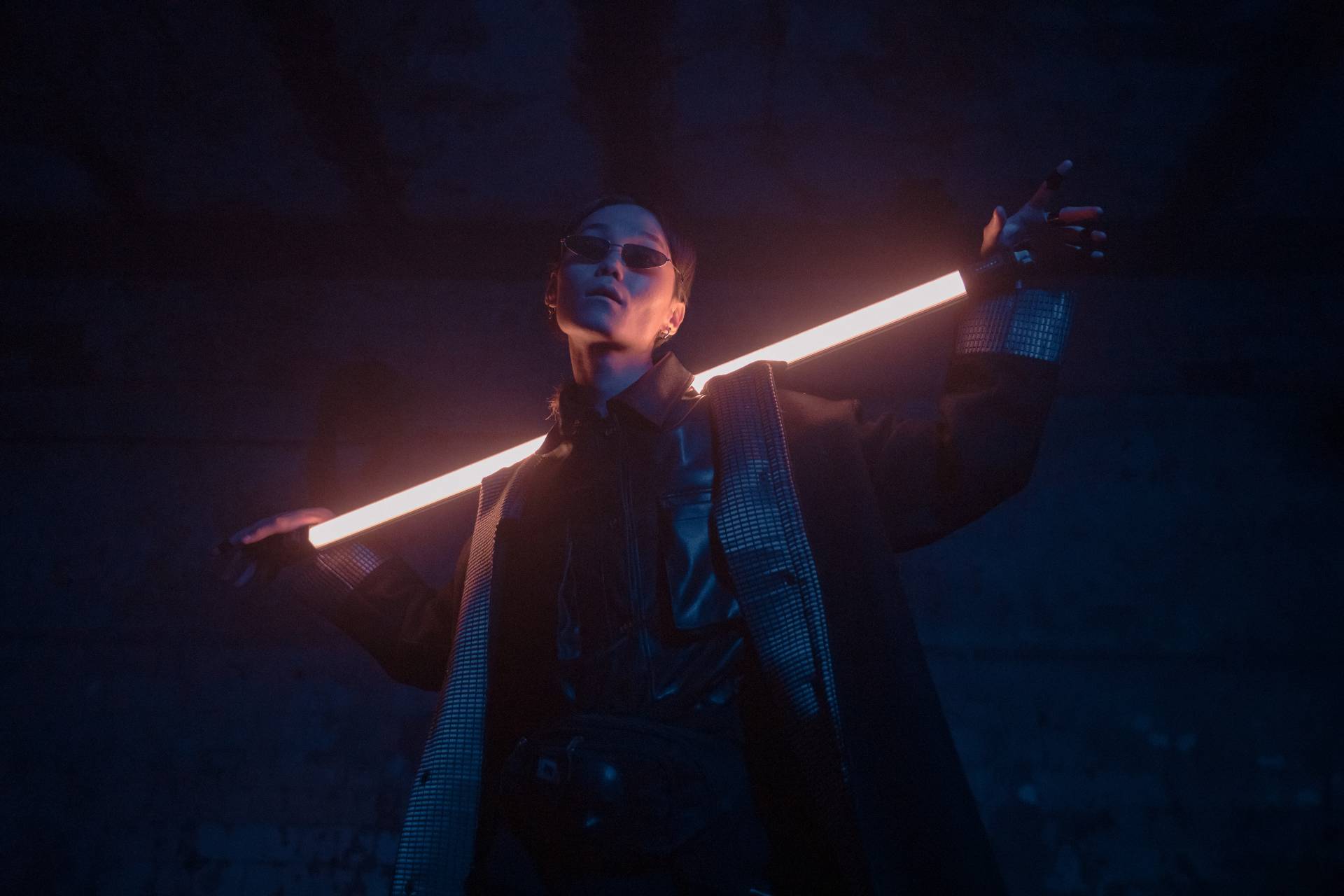 a woman holding a light saber